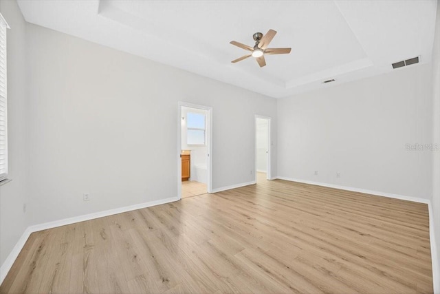 1760 Mountclair Ct, Mount Dora, FL 32757 - spare room with a raised ceiling, a ceiling fan, and light wood-style floors