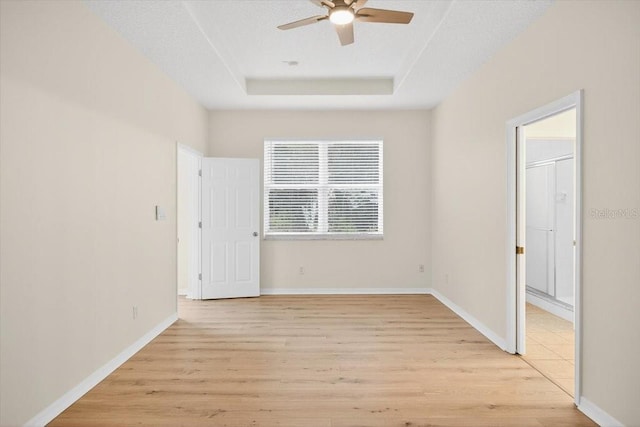 1760 Mountclair Ct, Mount Dora, FL 32757 - empty room with ceiling fan, a raised ceiling, and light wood-type flooring