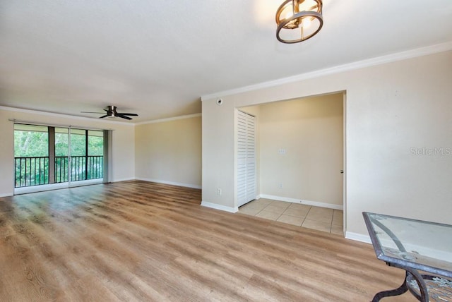 200 Country Club Dr Unit 1402, Largo, FL 33771 - unfurnished living room with crown molding, a ceiling fan, and light wood finished floors