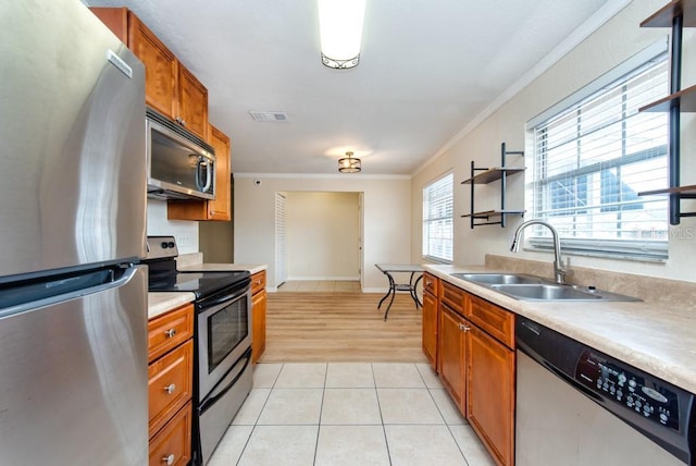 200 Country Club Dr Unit 1402, Largo, FL 33771 - kitchen featuring appliances with stainless steel finishes, crown molding, brown cabinets, light countertops, and open shelves