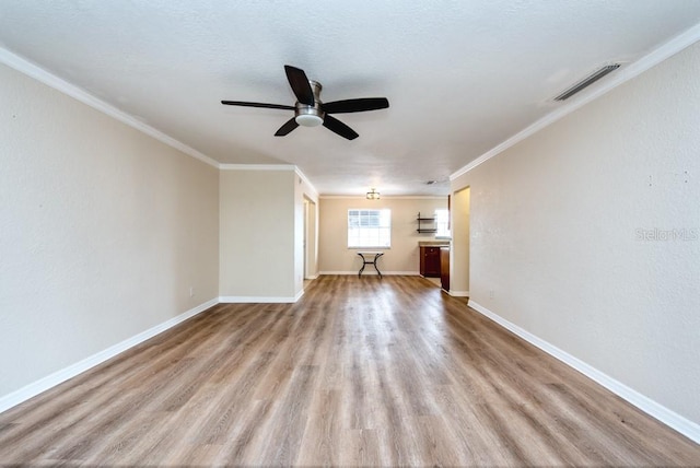 200 Country Club Dr Unit 1402, Largo, FL 33771 - spare room featuring wood finished floors, a ceiling fan, and ornamental molding