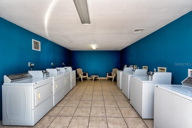 200 Country Club Dr Unit 1402, Largo, FL 33771 - shared laundry with washer and dryer and light tile patterned flooring