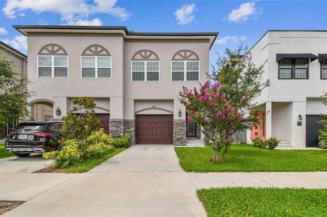 2405 W N B St Unit 1, Tampa, FL 33609 - multi unit property featuring stucco siding, concrete driveway, a garage, stone siding, and a front lawn