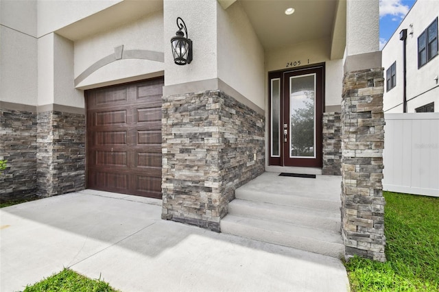 2405 W N B St Unit 1, Tampa, FL 33609 - doorway to property featuring stucco siding, stone siding, and driveway