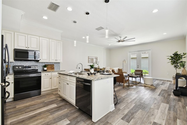 2405 W N B St Unit 1, Tampa, FL 33609 - kitchen with appliances with stainless steel finishes, recessed lighting, ceiling fan, tasteful backsplash, and an island with sink