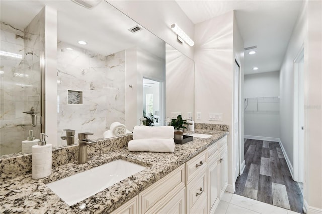 2405 W N B St Unit 1, Tampa, FL 33609 - full bath featuring double vanity, a marble finish shower, a spacious closet, and recessed lighting