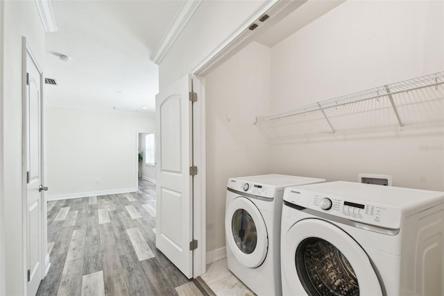 2405 W N B St Unit 1, Tampa, FL 33609 - laundry area featuring washer and clothes dryer, light wood finished floors, and ornamental molding