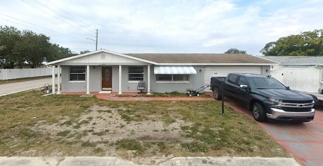 3243 Umber Rd, Holiday, FL 34691 - ranch-style house with an attached garage, concrete driveway, and a porch