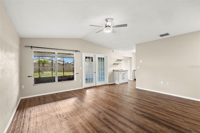 1421 Vinetree Dr, Brandon, FL 33510 - unfurnished living room featuring a ceiling fan, dark wood-type flooring, vaulted ceiling, and french doors