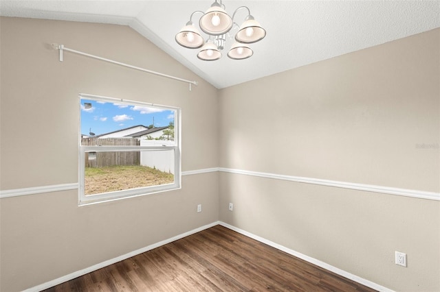 1421 Vinetree Dr, Brandon, FL 33510 - spare room with a chandelier, vaulted ceiling, and wood finished floors