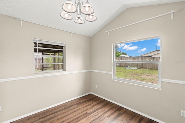 1421 Vinetree Dr, Brandon, FL 33510 - spare room with a chandelier, plenty of natural light, wood finished floors, and vaulted ceiling