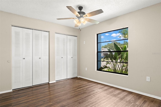 1421 Vinetree Dr, Brandon, FL 33510 - unfurnished bedroom featuring two closets, wood finished floors, ceiling fan, and a textured ceiling