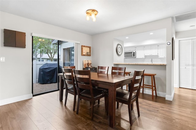 200 Gretchen Ct, Oldsmar, FL 34677 - dining space featuring wood finished floors and recessed lighting