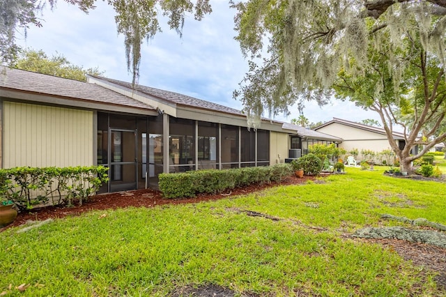 200 Gretchen Ct, Oldsmar, FL 34677 - rear view of property featuring a sunroom and a yard
