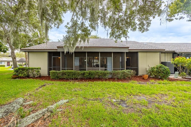 200 Gretchen Ct, Oldsmar, FL 34677 - back of house with a sunroom and a yard