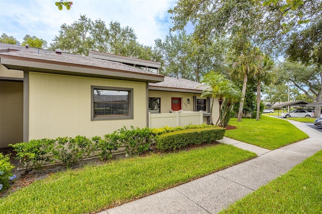 200 Gretchen Ct, Oldsmar, FL 34677 - view of property exterior with a lawn and a shingled roof