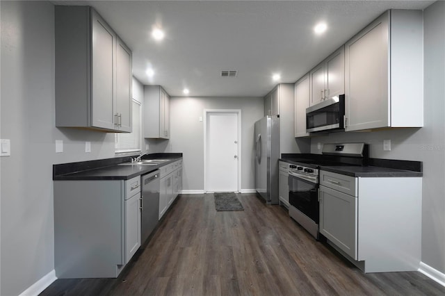 5018 Pine St, Seffner, FL 33584 - kitchen featuring appliances with stainless steel finishes, dark countertops, dark wood-style floors, and recessed lighting