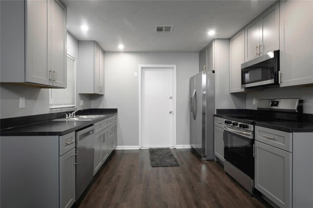 5018 Pine St, Seffner, FL 33584 - kitchen with stainless steel appliances, dark countertops, dark wood finished floors, and recessed lighting