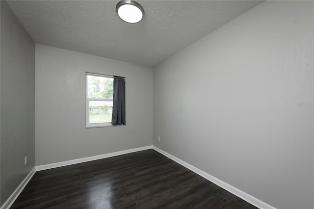 5018 Pine St, Seffner, FL 33584 - empty room featuring dark wood-style flooring and a textured ceiling