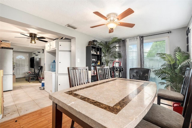2149 Dixie Garden Loop, Holiday, FL 34690 - dining area featuring a ceiling fan, an office area, and light wood-type flooring