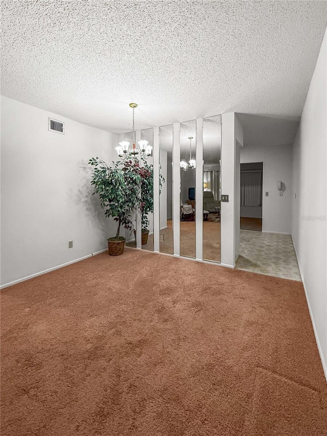 2460 Persian Dr Unit 44, Clearwater, FL 33763 - unfurnished room with a chandelier, carpet, and a textured ceiling