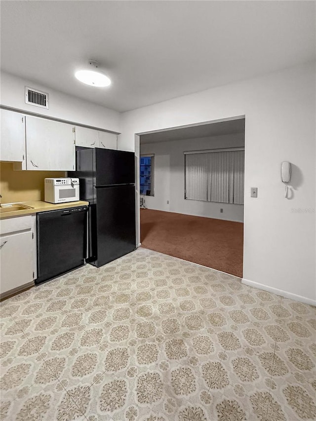 2460 Persian Dr Unit 44, Clearwater, FL 33763 - kitchen with black appliances, light countertops, and white cabinetry
