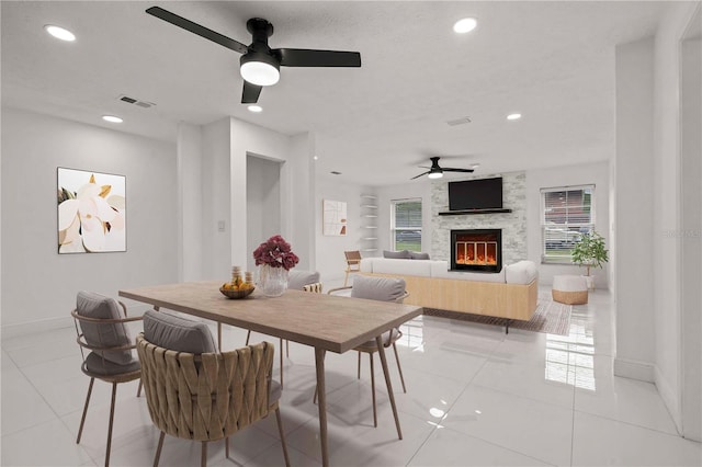 210 Lake Hobbs Rd, Lutz, FL 33548 - dining space with ceiling fan, recessed lighting, a stone fireplace, and light tile patterned flooring