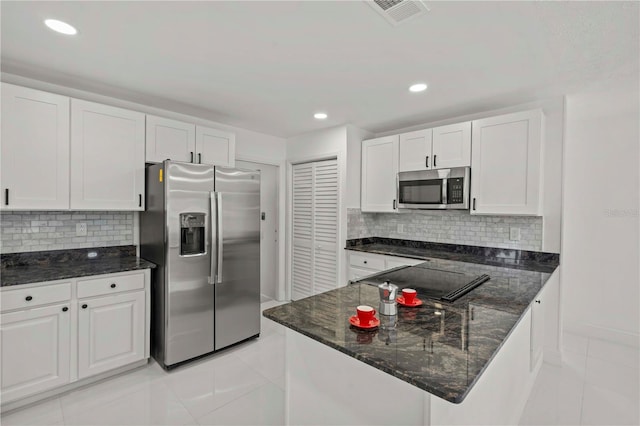 210 Lake Hobbs Rd, Lutz, FL 33548 - kitchen featuring appliances with stainless steel finishes, light tile patterned flooring, white cabinets, dark stone countertops, and recessed lighting