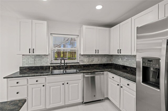 210 Lake Hobbs Rd, Lutz, FL 33548 - kitchen featuring stainless steel appliances, white cabinets, dark stone countertops, and recessed lighting
