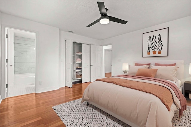 210 Lake Hobbs Rd, Lutz, FL 33548 - bedroom with light wood-style flooring, a closet, connected bathroom, and a ceiling fan
