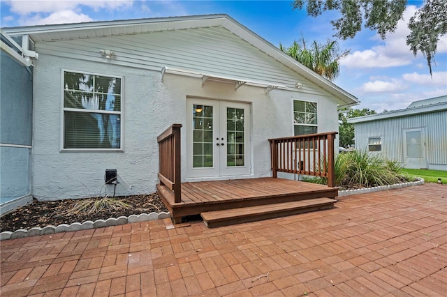 210 Lake Hobbs Rd, Lutz, FL 33548 - rear view of property with french doors, stucco siding, a patio area, and a wooden deck