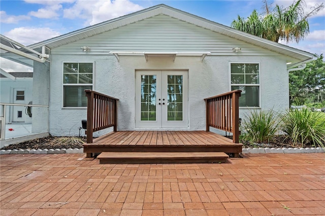 210 Lake Hobbs Rd, Lutz, FL 33548 - rear view of property featuring french doors, stucco siding, and a wooden deck