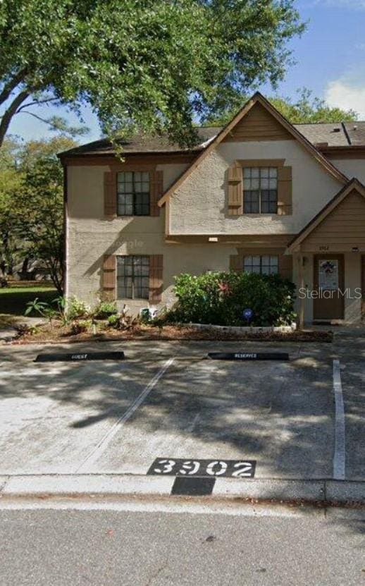 3902 Brigadoon Cir, Clearwater, FL 33759 - tudor home with uncovered parking and stucco siding