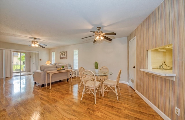 2206 Cordova Grn Unit 2206, Seminole, FL 33777 - dining room with ceiling fan and light wood-style floors