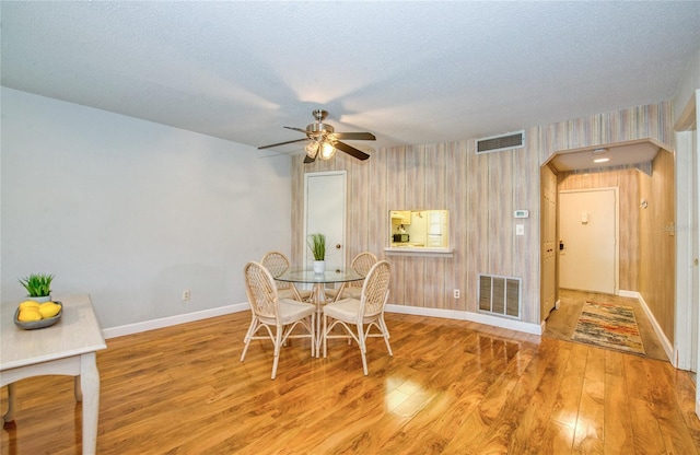 2206 Cordova Grn Unit 2206, Seminole, FL 33777 - dining room with a ceiling fan, wood finished floors, and a textured ceiling