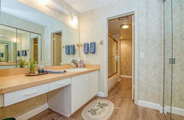 2206 Cordova Grn Unit 2206, Seminole, FL 33777 - full bath with wood finished floors, vanity, and wallpapered walls