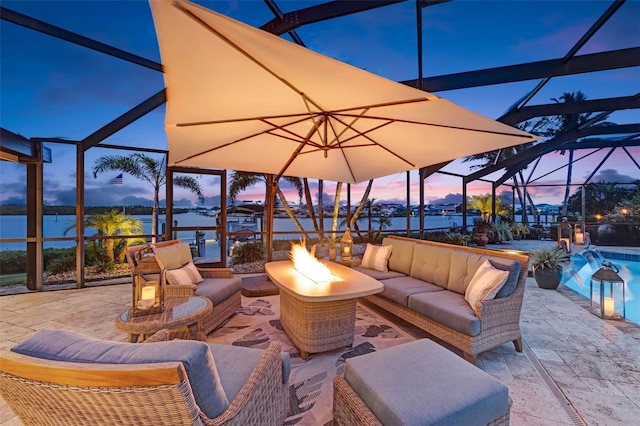 6605 Seabird Way, Apollo Beach, FL 33572 - view of patio featuring a lanai, an outdoor living space with a fire pit, an outdoor pool, and a water view