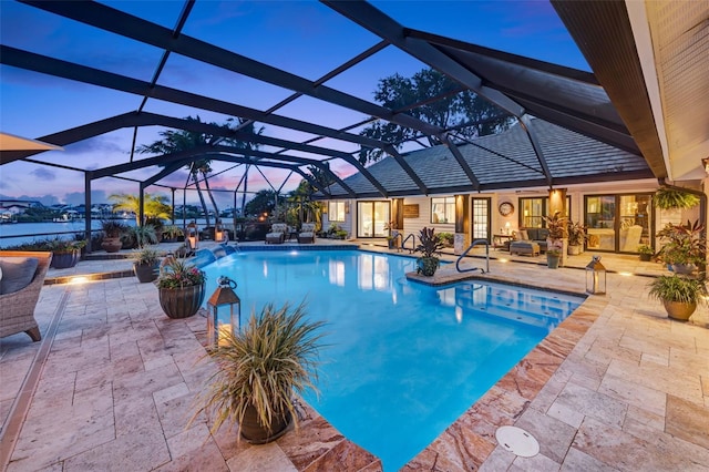 6605 Seabird Way, Apollo Beach, FL 33572 - pool at dusk featuring an outdoor pool, a patio area, and a lanai