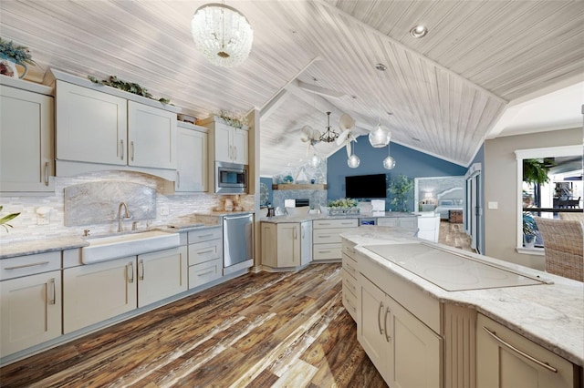 6605 Seabird Way, Apollo Beach, FL 33572 - kitchen featuring appliances with stainless steel finishes, open floor plan, dark wood-style floors, lofted ceiling, and a chandelier