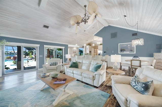 6605 Seabird Way, Apollo Beach, FL 33572 - living room featuring a chandelier, wood finished floors, wooden ceiling, vaulted ceiling, and a wainscoted wall