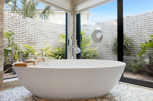 6605 Seabird Way, Apollo Beach, FL 33572 - full bath with a freestanding tub and healthy amount of natural light