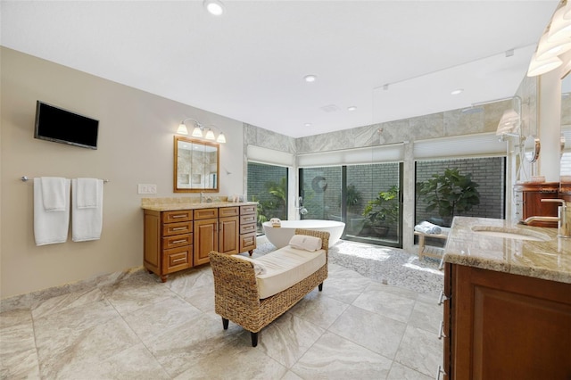 6605 Seabird Way, Apollo Beach, FL 33572 - bathroom featuring two vanities, a soaking tub, and recessed lighting