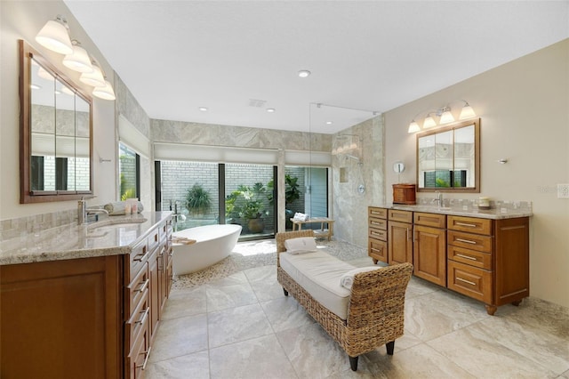 6605 Seabird Way, Apollo Beach, FL 33572 - full bathroom with tiled shower, plenty of natural light, two vanities, a freestanding tub, and recessed lighting