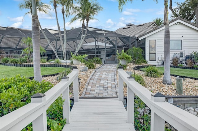 6605 Seabird Way, Apollo Beach, FL 33572 - back of house featuring glass enclosure and a yard