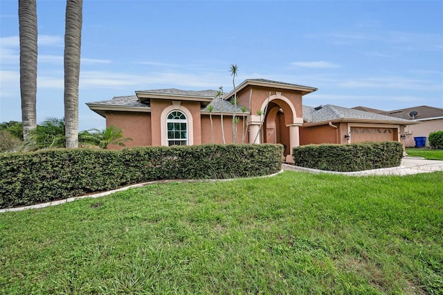3612 Covington Dr, Holiday, FL 34691 - mediterranean / spanish house featuring a garage, a front yard, stucco siding, and concrete driveway