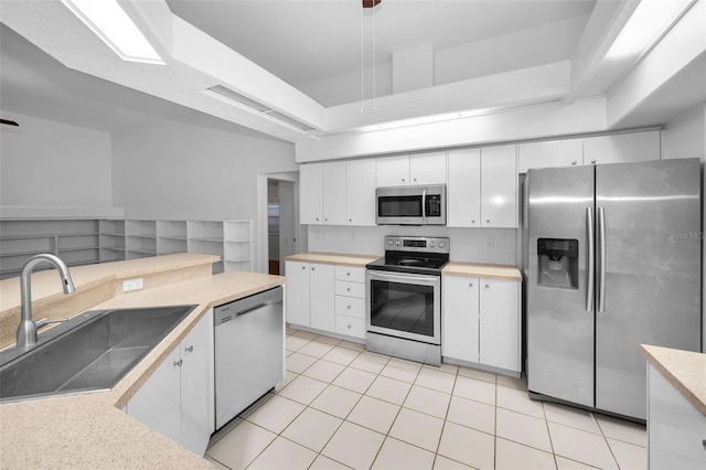 3612 Covington Dr, Holiday, FL 34691 - kitchen featuring appliances with stainless steel finishes, white cabinetry, and light tile patterned flooring