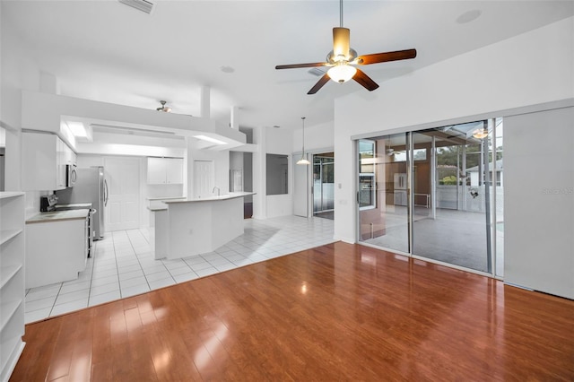 3612 Covington Dr, Holiday, FL 34691 - unfurnished living room featuring a ceiling fan and light wood-style floors