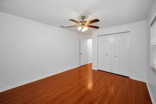 3612 Covington Dr, Holiday, FL 34691 - unfurnished bedroom featuring wood finished floors, a closet, and ceiling fan