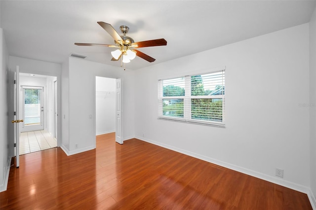 3612 Covington Dr, Holiday, FL 34691 - unfurnished bedroom with wood finished floors, a closet, and ceiling fan