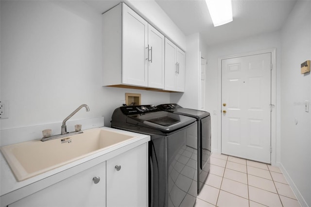 3612 Covington Dr, Holiday, FL 34691 - laundry area featuring washing machine and clothes dryer, cabinet space, and light tile patterned floors